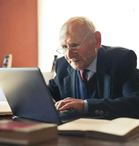 Older man using a laptop computer.