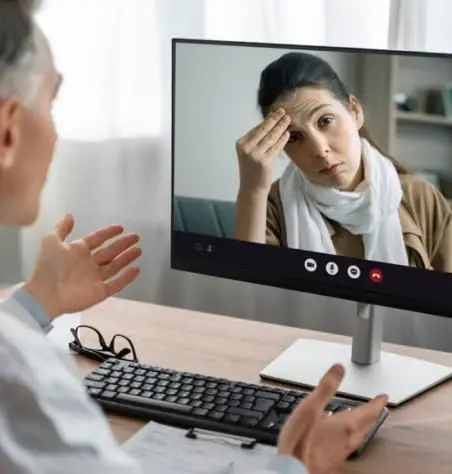 Doctor listening to patient on video call.